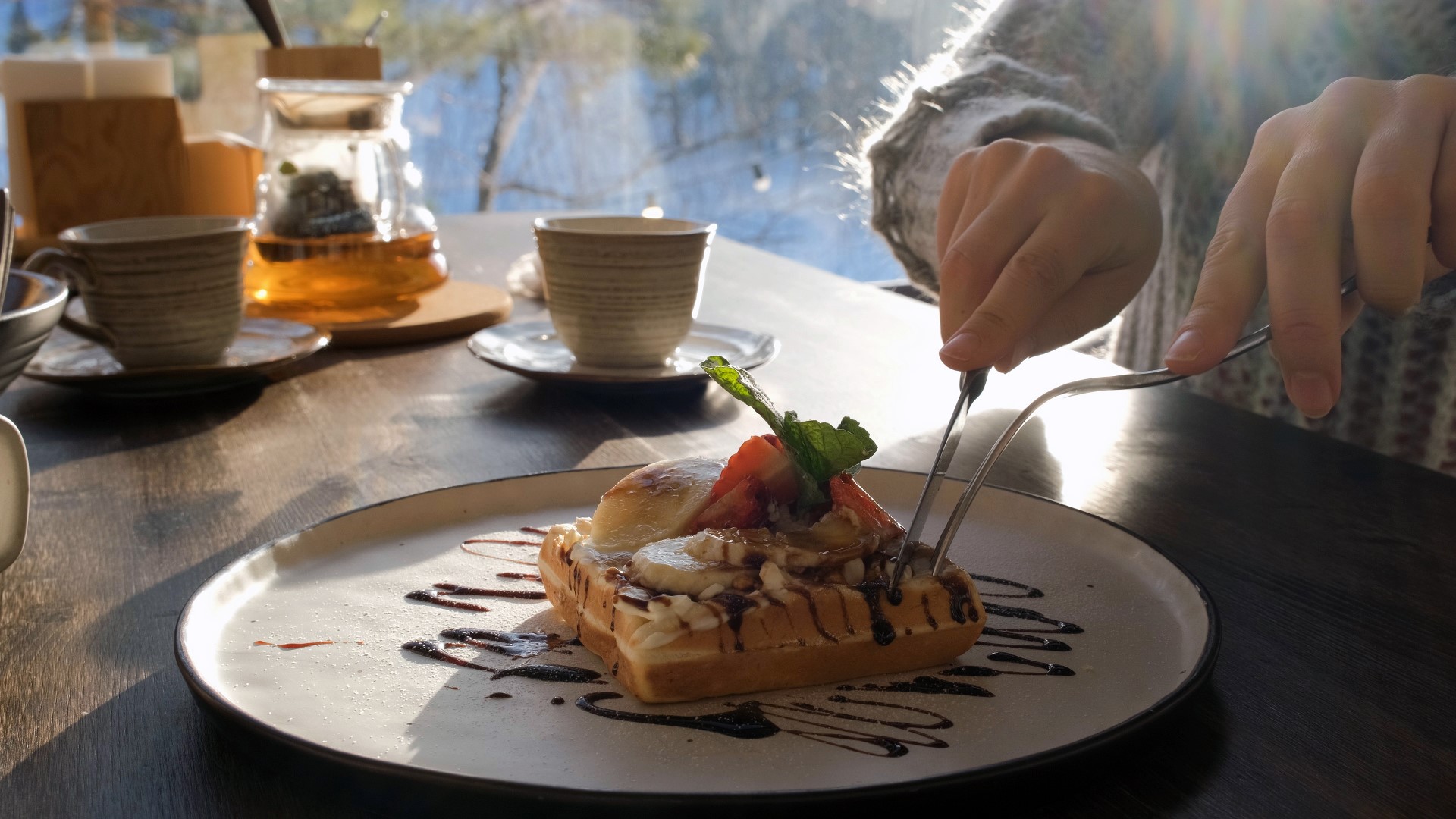 close-upofayoungwomanenjoyingasweetwaffledessert-2